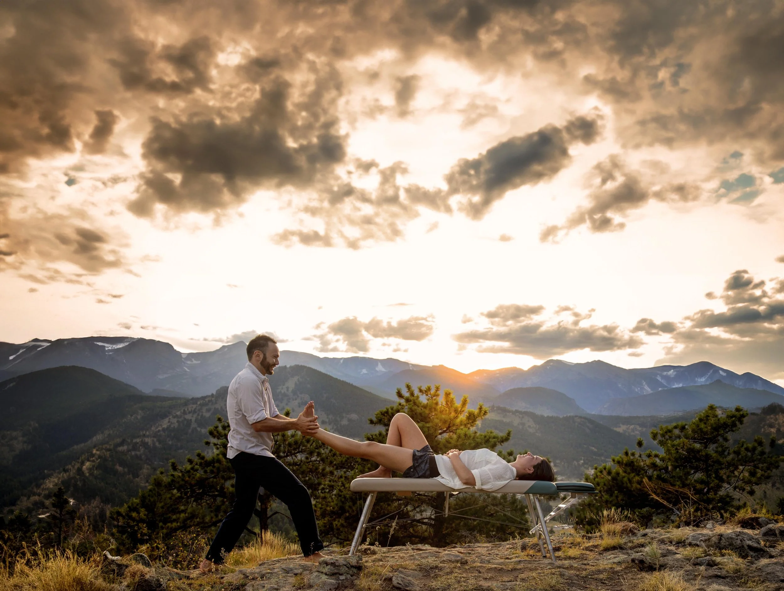 Dr. Dylan adjusting a patient outdoors in the Boulder mountains